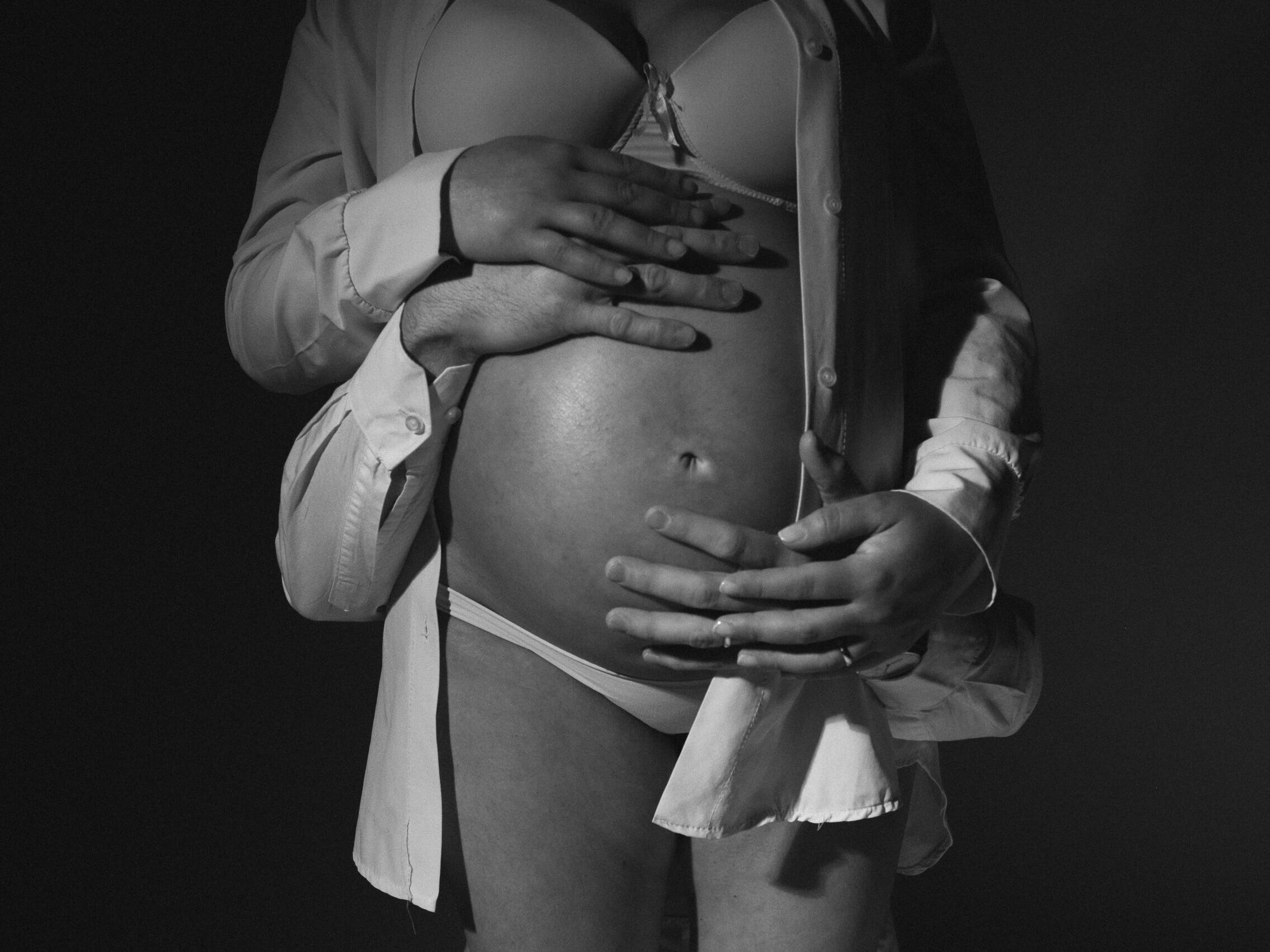 Couple with pregnant woman and their hands